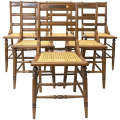 Front view of six American Sheraton chairs with cane seats.