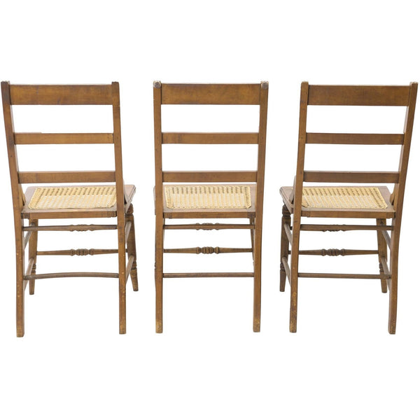 Back view of three of the American Sheraton chairs with cane seats.