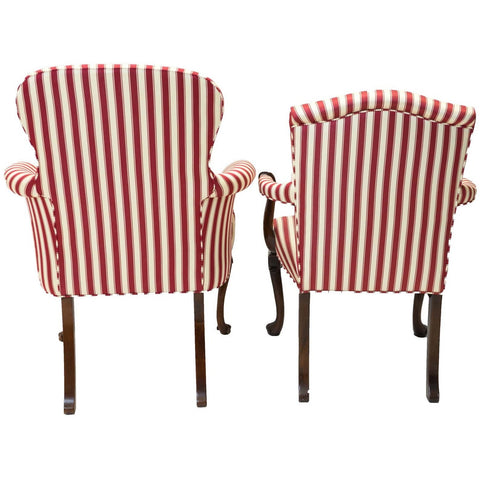 Side view of a pair of red and white striped parlor chairs.