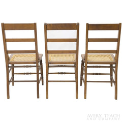 Back view of three of the American Sheraton chairs with cane seats.