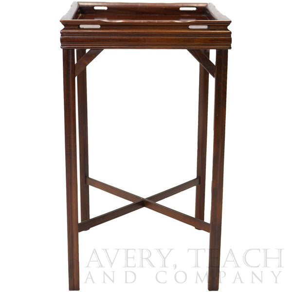 Side view of an antique mahogany end table with a simple fluted design and a cross bar between the legs.
